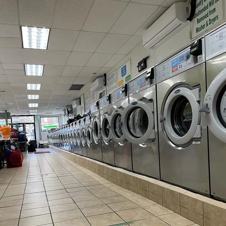A long row of front-load washers inside the Green Spin laundromat